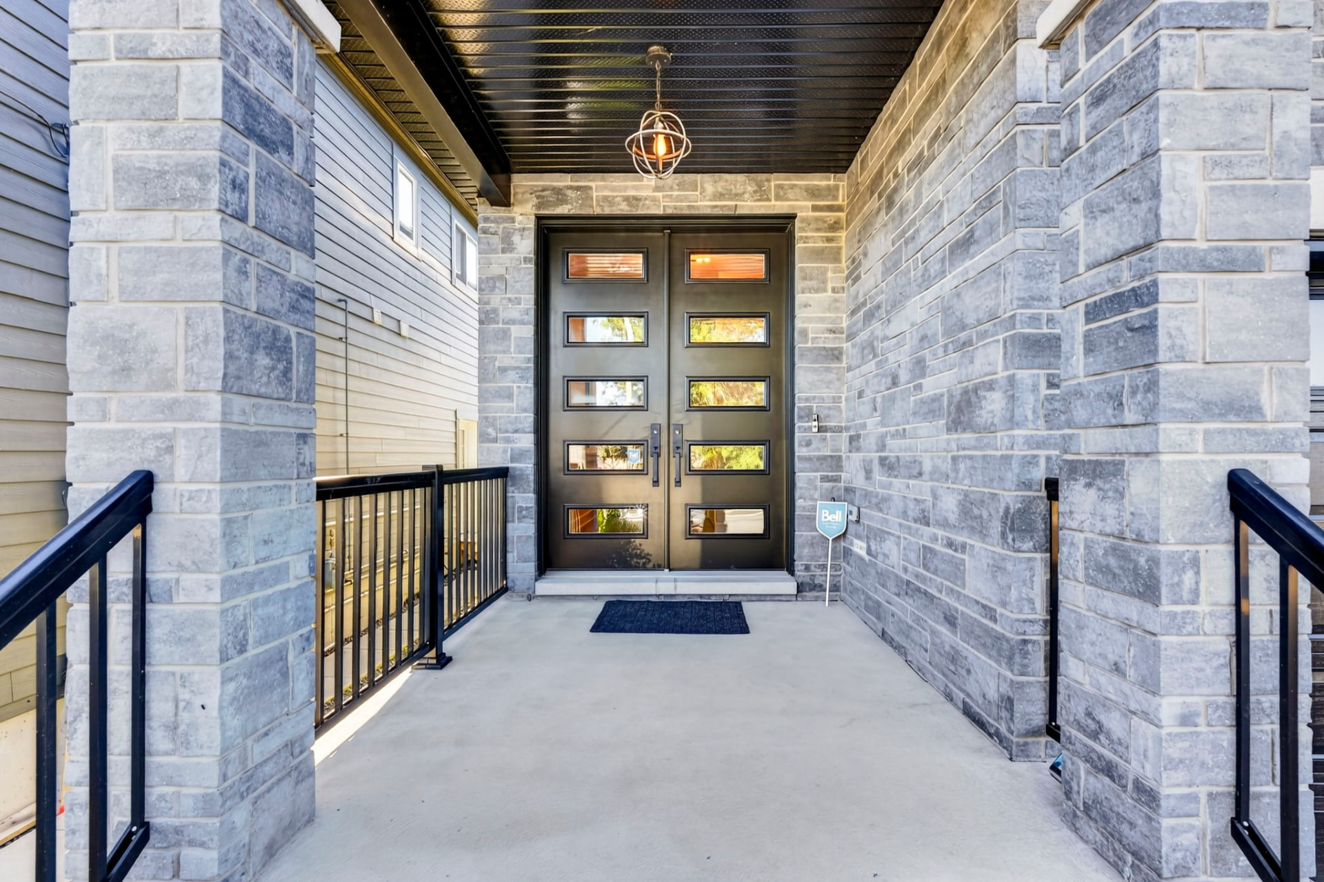 Covered stone entrance with double doors